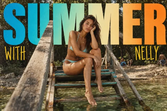 Adult woman in aqua swimwear seated on a rustic lakeside ladder with retro multicolor SUMMER lettering across the upper frame.