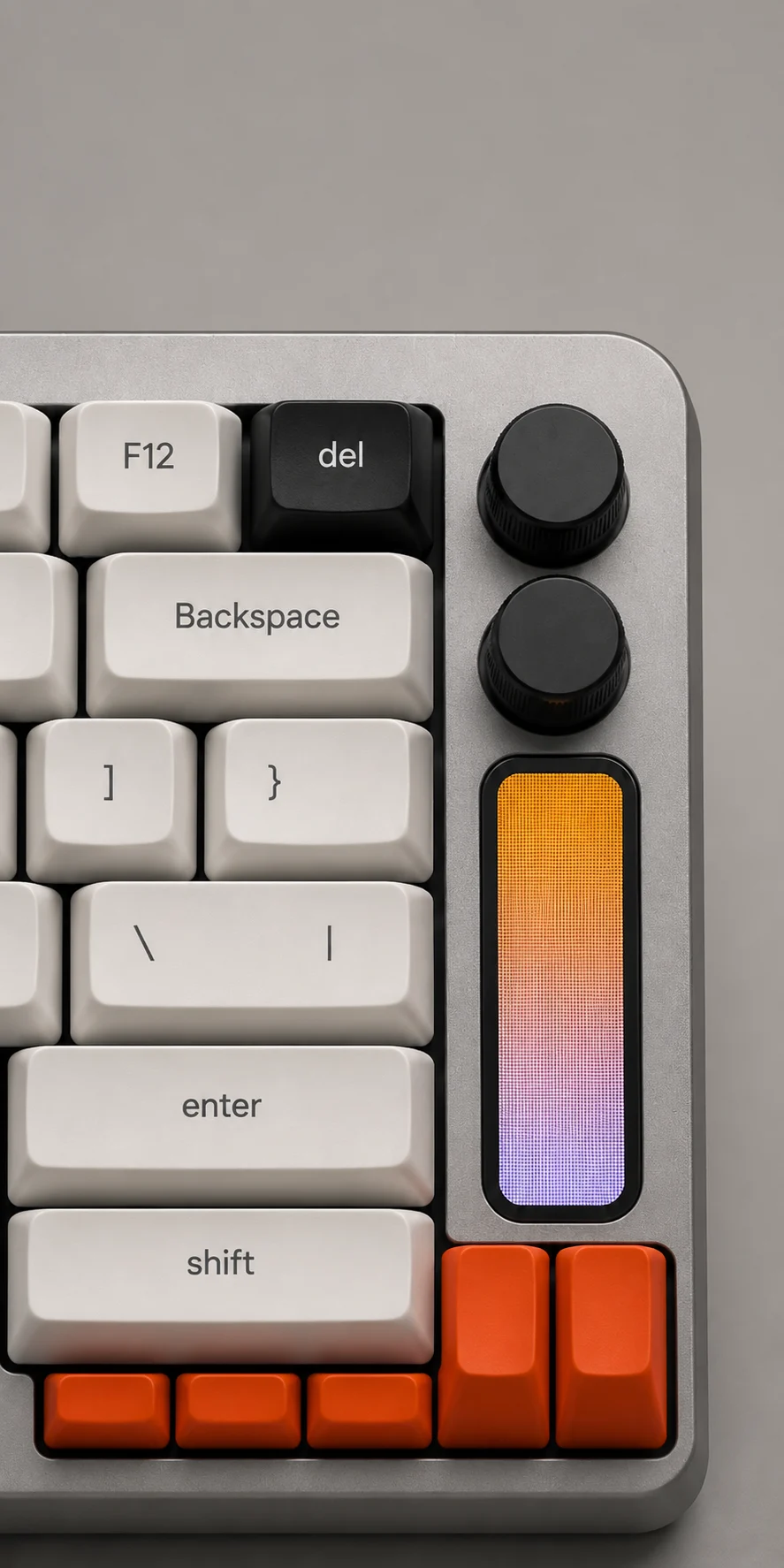 Minimal product render of a compact mechanical keyboard with orange accent keys and illuminated vertical control display.
