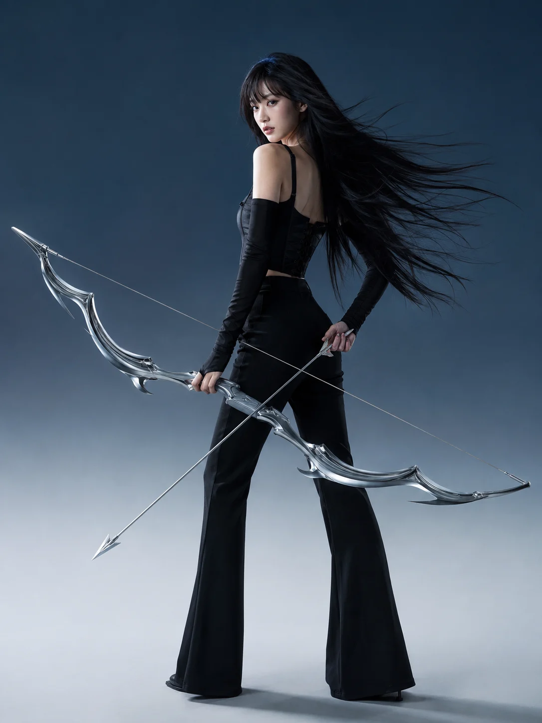 Dark fashion portrait of a model in black holding a large silver bow in a minimalist cool-toned studio.