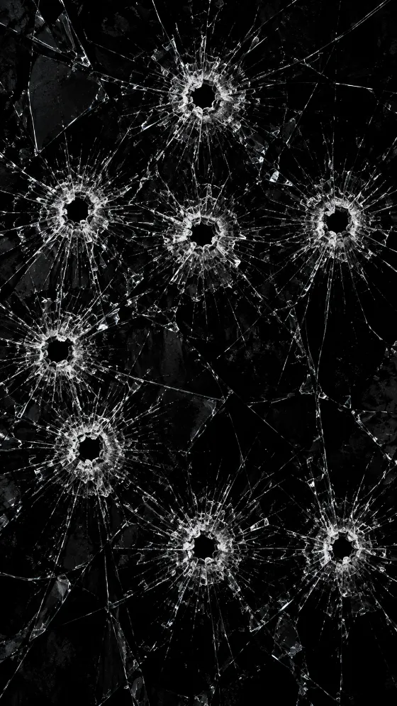 Black glass surface with eight bright shattered bullet-impact patterns and radial white cracks.