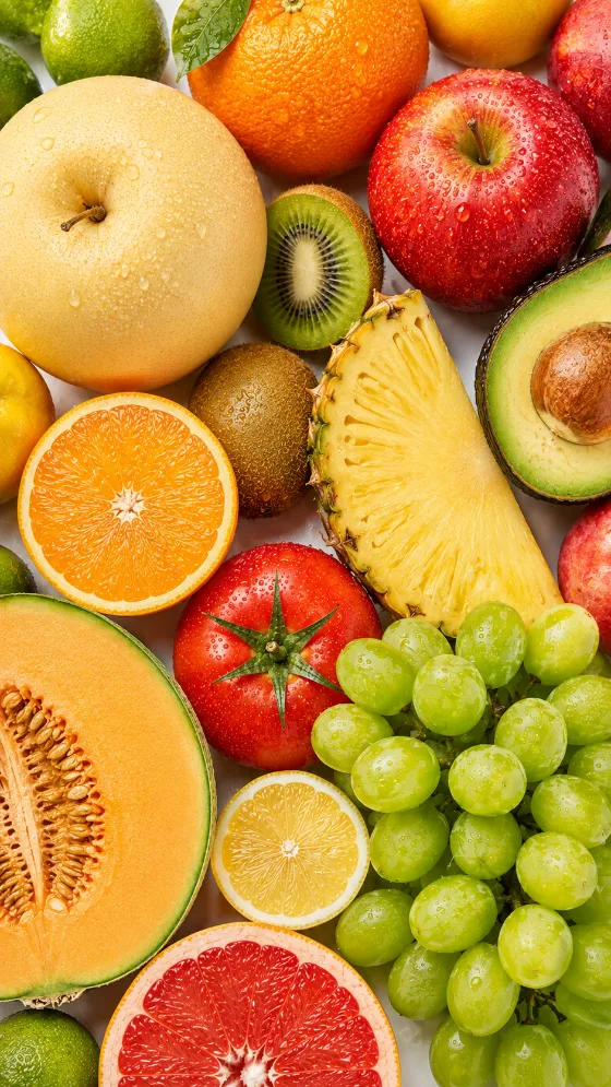 Colorful mixed fruit arranged in an overhead flat lay on a clean white background.