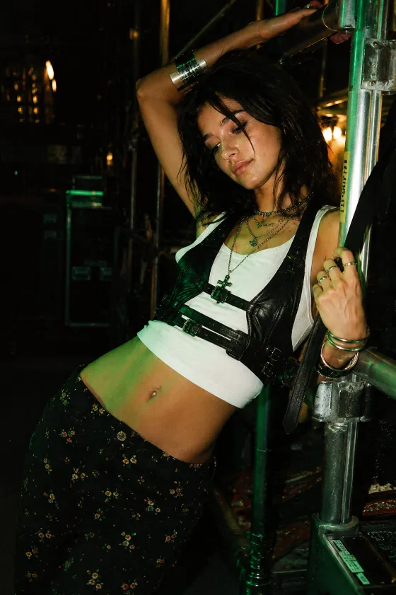 Edgy industrial streetwear with harness details and saturated green amber lighting