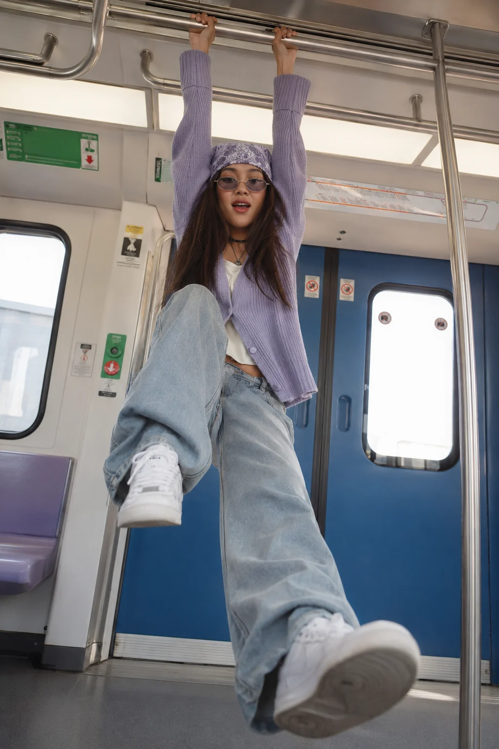 Low-angle metro fashion editorial with suspended pose.
