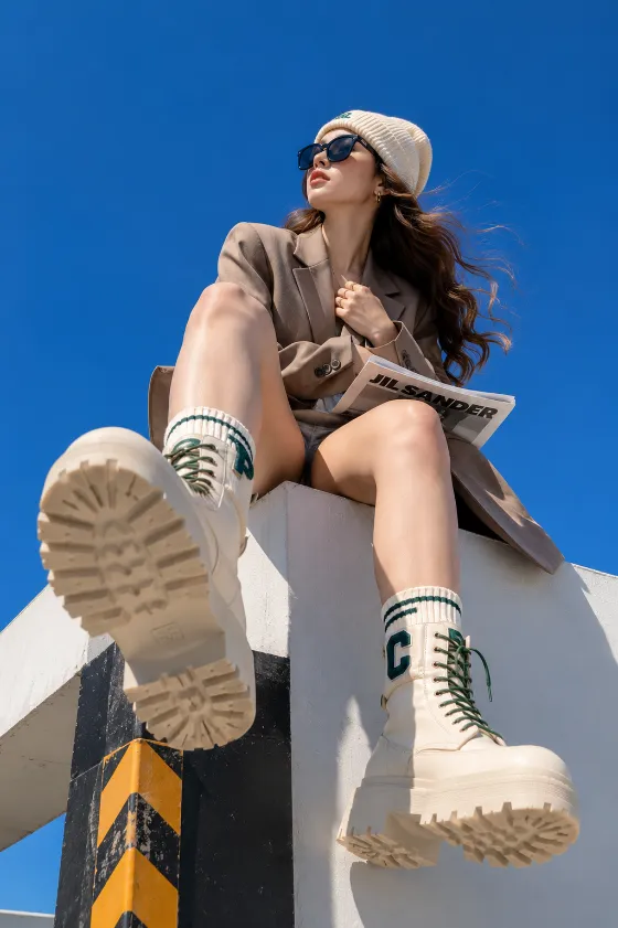 Extreme low-angle rooftop editorial fashion image with oversized combat boots.