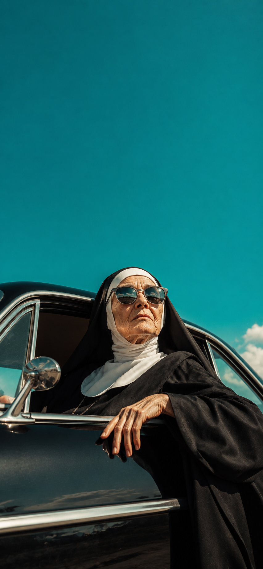 Editorial portrait of an elderly woman in a traditional habit wearing sunglasses beside a vintage car.