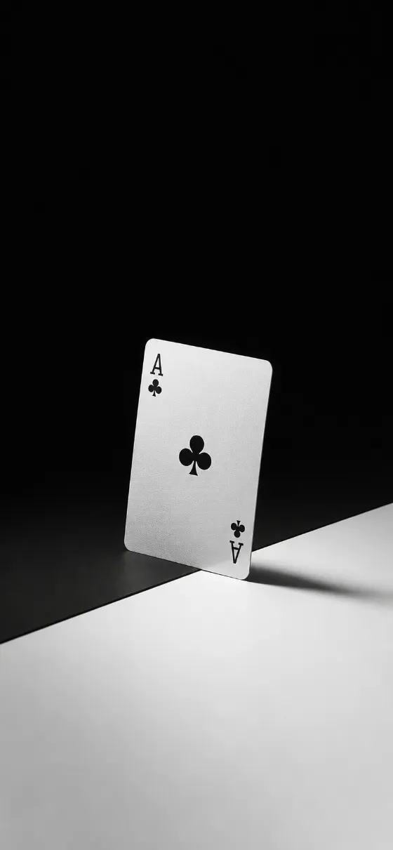 A single Ace of Clubs playing card standing on a minimalist black-and-white studio background.