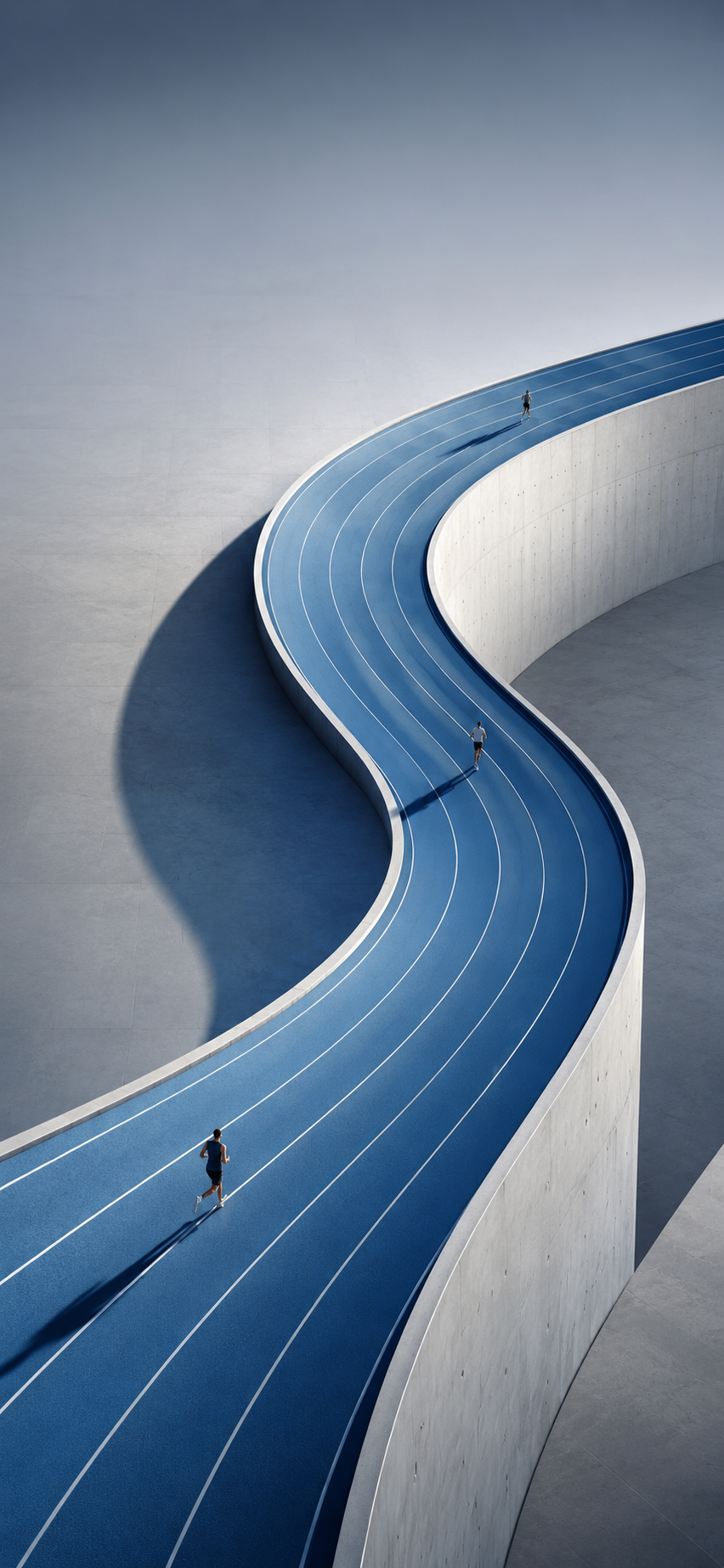 Aerial view of a curved blue running track with runners casting long shadows.