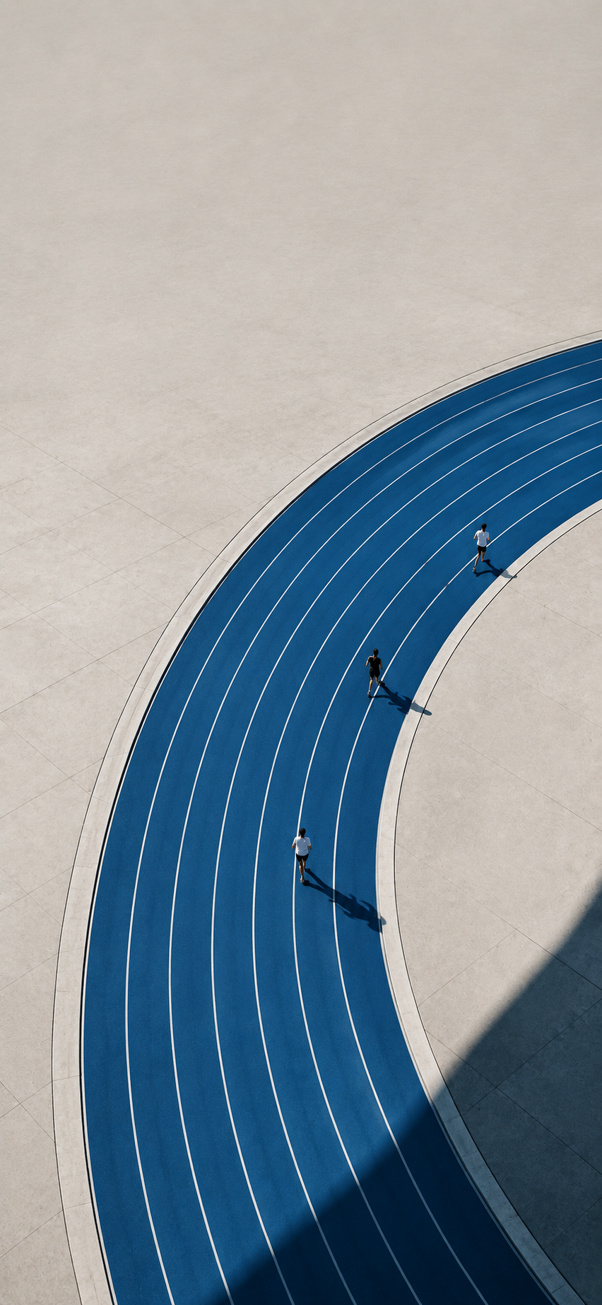 Aerial view of a curved blue running track with scattered runners casting long shadows in a minimalist composition.