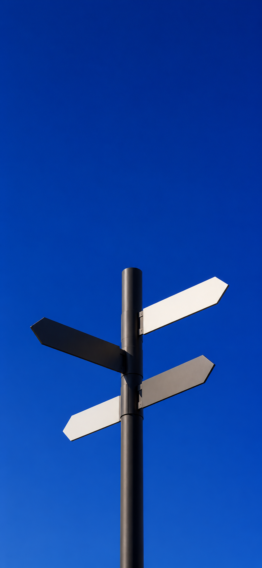 Minimal white and gray signpost standing against a vivid blue background with clean architectural styling.