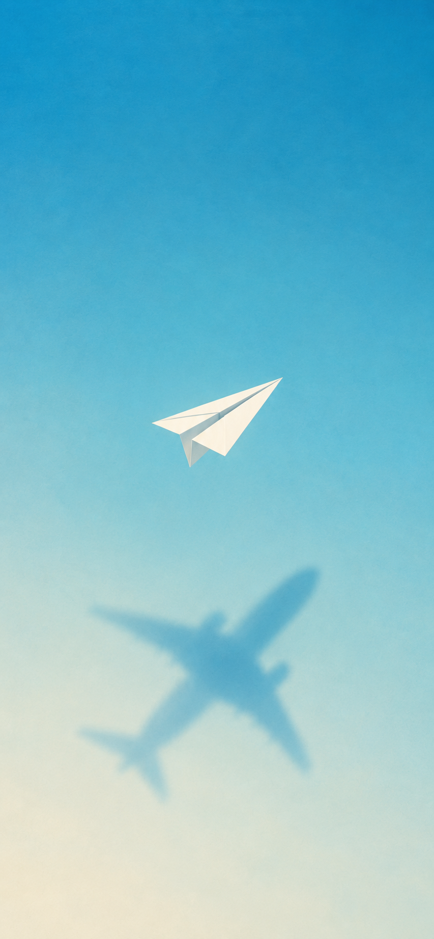 Minimal blue sky wallpaper with a white paper airplane casting the shadow of a passenger aircraft.