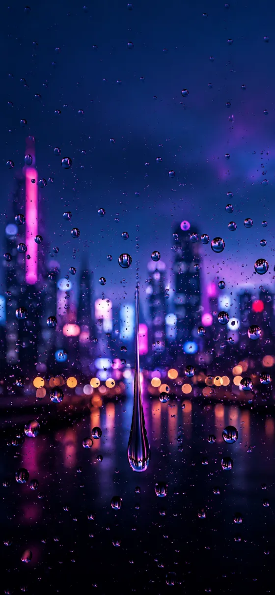Sharp raindrops on a dark window with blurred magenta and violet city lights glowing in the rainy night background.
