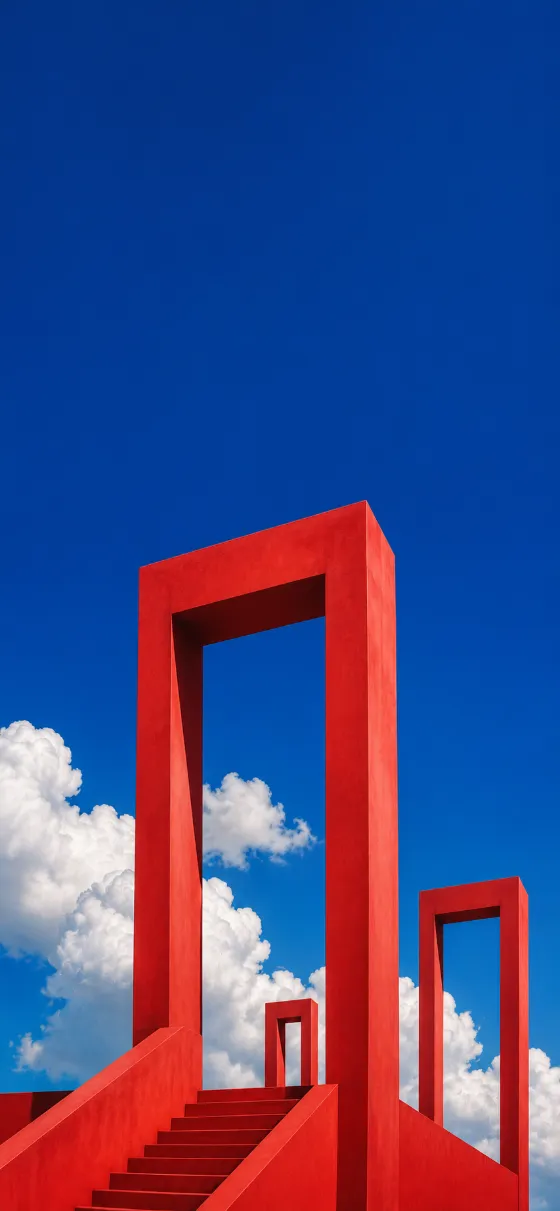 Minimal red architectural frames extending into a vivid blue sky with soft white clouds.