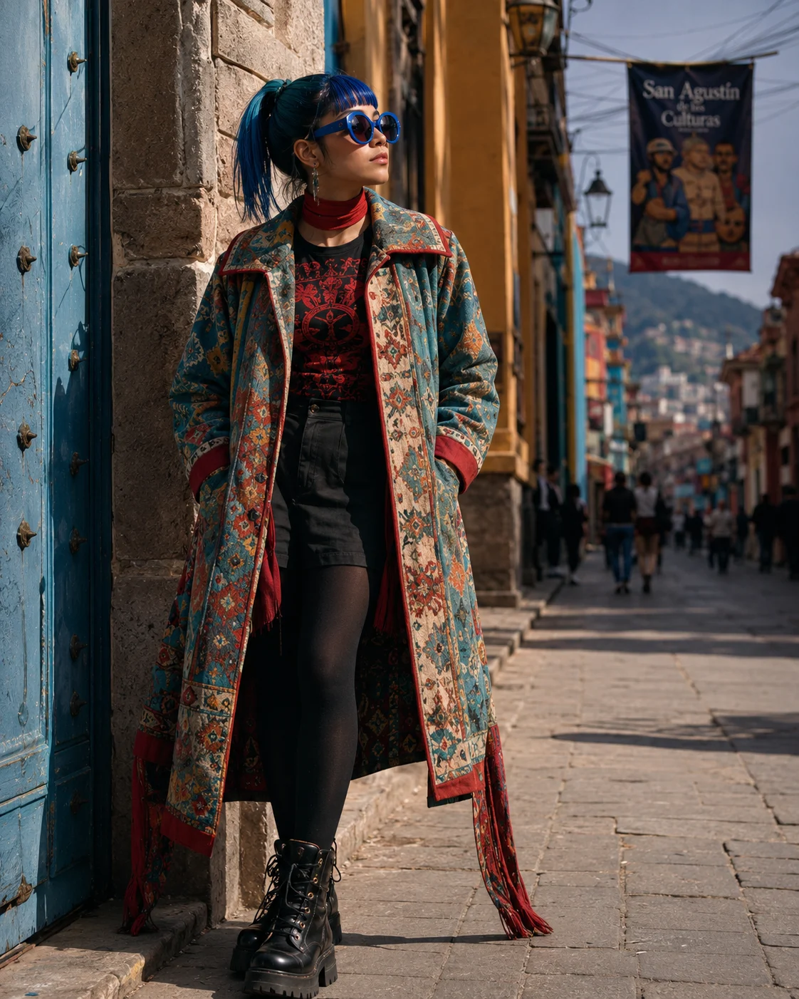Woman in multicolor tapestry coat, cobalt ponytail, blue round sunglasses, standing on a historic street with ochre façades, cinematic fashion editorial.