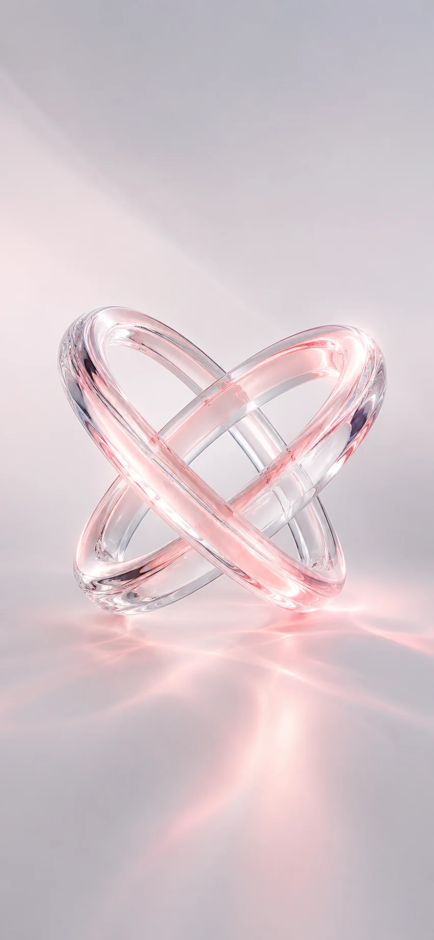 Transparent intertwined glass rings with pink glow on a soft pastel reflective background.