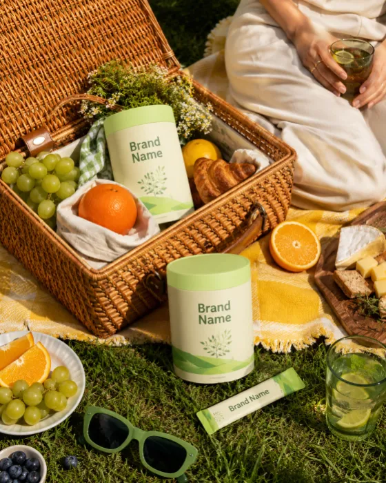 Healthy supplement products arranged in a premium outdoor picnic setting with sanitized branding.