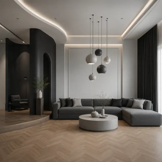 Luxury gray living room with curved charcoal partition, gray sectional, spherical pendant lights, pale coffee table, and herringbone flooring.