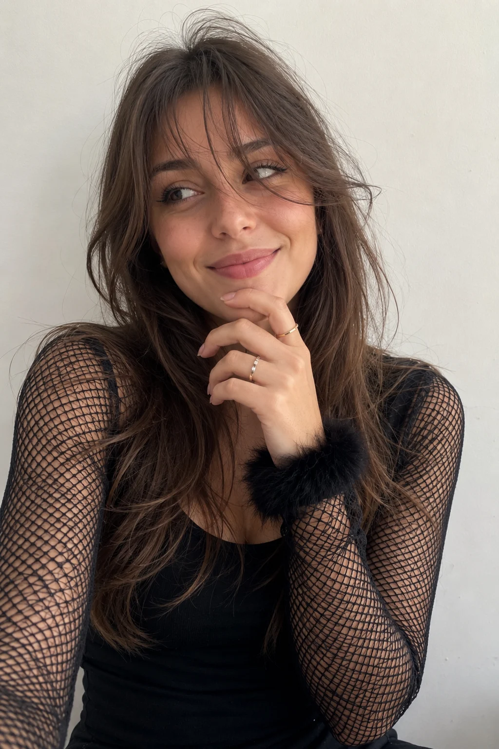 woman in studio, shown with smartphone-style photo styling.