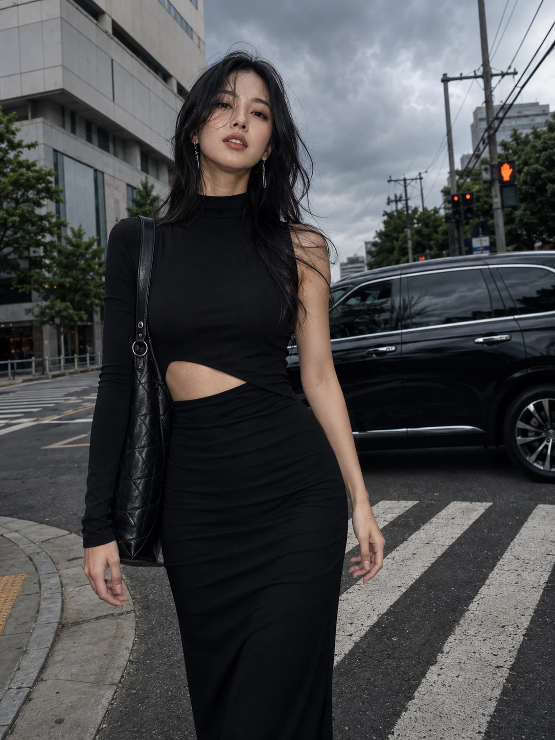 Vertical street-fashion portrait of a model wearing a long black cutout dress at an urban intersection.