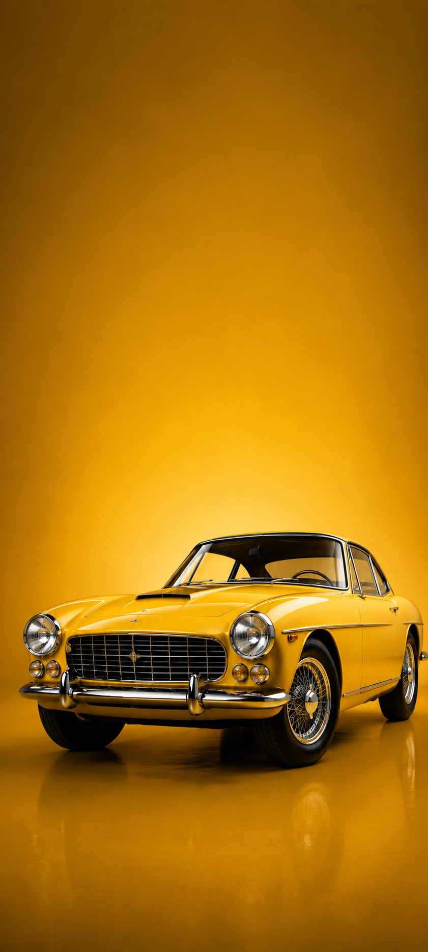 Yellow vintage classic sedan cropped in a front three-quarter view against a clean yellow studio background.